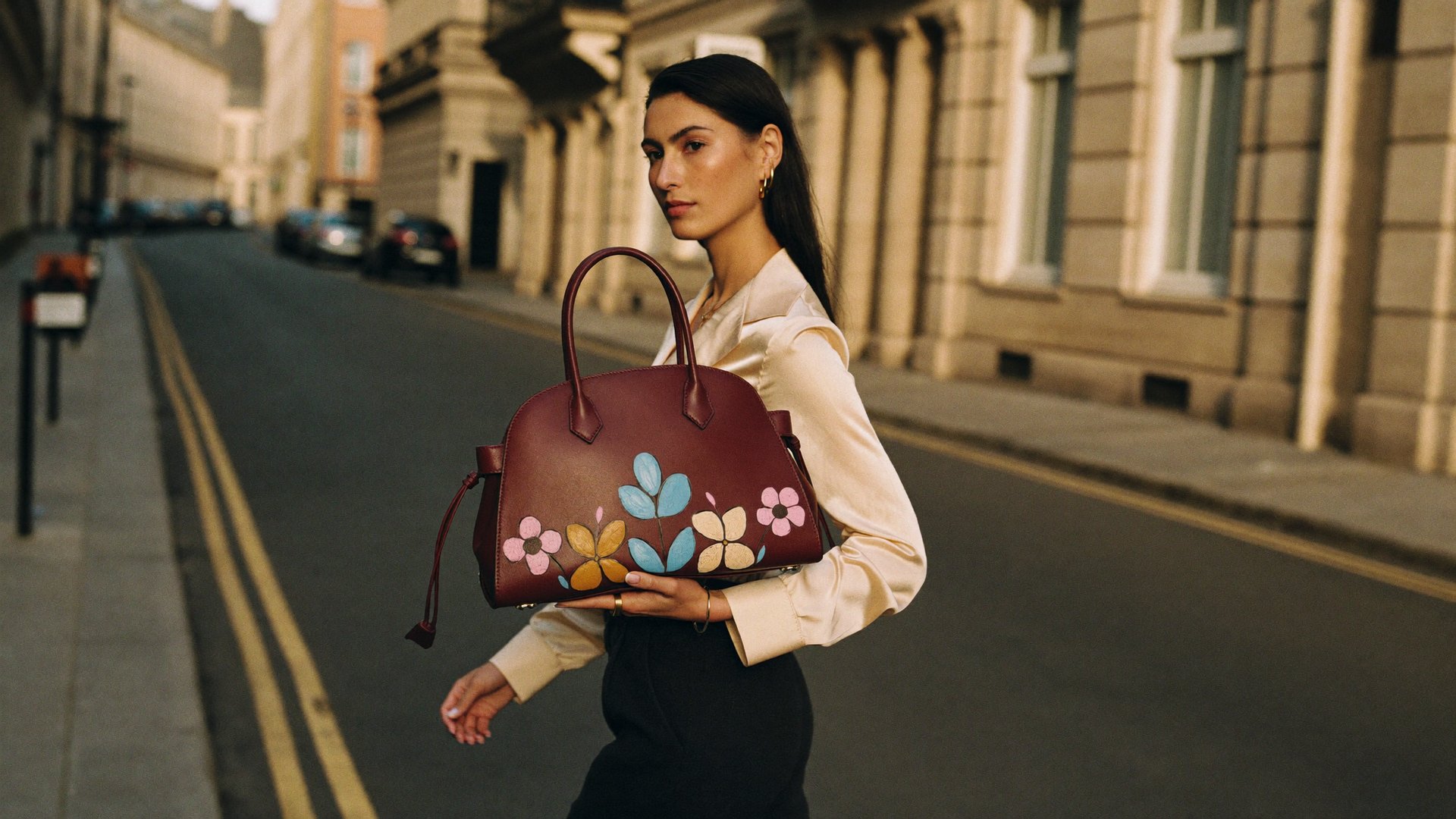 Hand-painted bucket bag in a Bloomsbury London street at golden hour