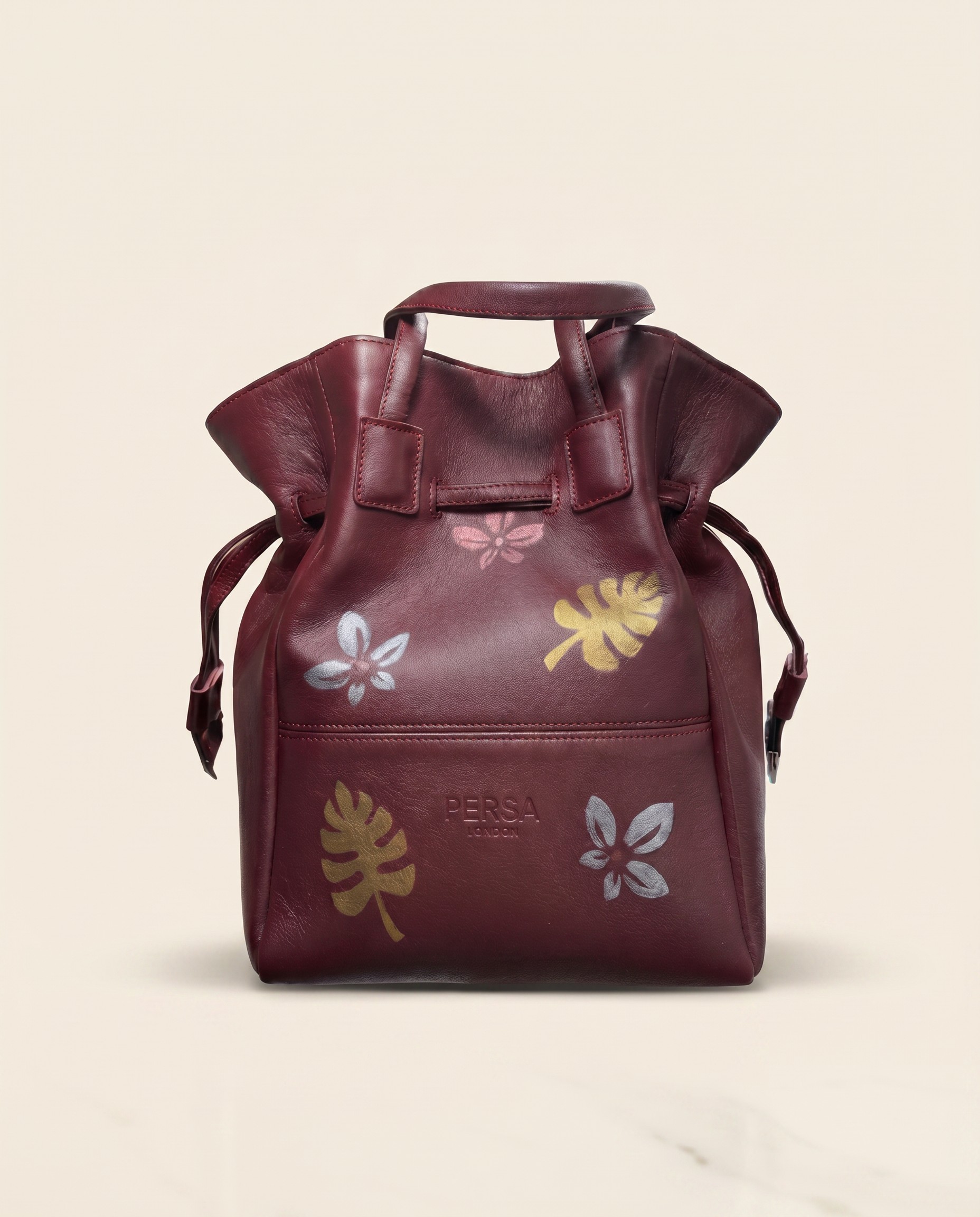 Hand-painted leather bucket bag in burgundy with gold floral brushwork