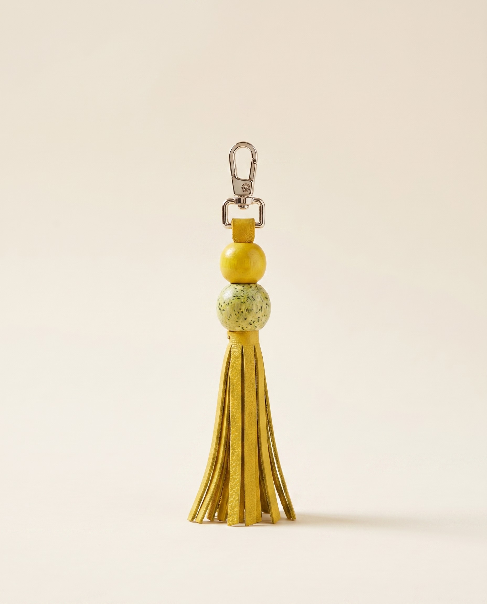Small hand-painted leather bag charm on a key ring